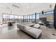 Open lounge area with sleek gray furnishings, floor-to-ceiling windows, a TV, and an accent wall at 4225 Ridgewalk Pt, Castle Rock, CO 80108