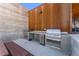 Outdoor kitchen equipped with stainless steel grills, prep area, and a mini-fridge for alfresco dining at 4225 Ridgewalk Pt, Castle Rock, CO 80108