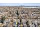 Elevated view of the neighborhood with a glimpse of the city skyline and a nearby lake at 2550 Kendall St, Edgewater, CO 80214