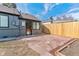 Cozy backyard featuring a stone patio, new fence, and garden bed, perfect for outdoor relaxation at 2550 Kendall St, Edgewater, CO 80214