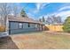 Exterior view of the backyard with a spacious yard, new fence, and well-maintained landscaping at 2550 Kendall St, Edgewater, CO 80214