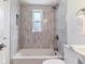 Cozy bathroom highlighting a tiled shower and bathtub with chrome fixtures at 2550 Kendall St, Edgewater, CO 80214