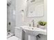 Well-lit bathroom with white sink, chrome fixtures, tiled wall, and a mirror at 2550 Kendall St, Edgewater, CO 80214