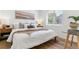 Relaxing bedroom with a bed with neutral decor, warm lighting, and wooden floors at 2550 Kendall St, Edgewater, CO 80214