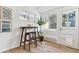 Breakfast nook with wood table, two stools, modern art, natural light, and a door at 2550 Kendall St, Edgewater, CO 80214