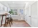 Breakfast nook with wood table, two stools, natural light, a door, and a closet at 2550 Kendall St, Edgewater, CO 80214