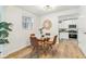 Cozy dining room with a round table, modern chairs, and a view into the kitchen, ideal for Gathering dinners at 2550 Kendall St, Edgewater, CO 80214