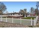 Charming home featuring a spacious, grassy backyard enclosed by a classic white picket fence at 5294 S Prescott St, Littleton, CO 80120