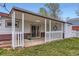 Charming covered patio featuring a white picket fence, garden space, and a cozy outdoor area at 5294 S Prescott St, Littleton, CO 80120
