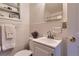 Clean white bathroom with tiled walls, decorative shelving and vanity sink at 5294 S Prescott St, Littleton, CO 80120