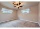 Bedroom with tan carpet, neutral paint, ceiling fan, and windows for natural light at 5294 S Prescott St, Littleton, CO 80120