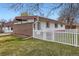 Exterior of a house with white and brick facade surrounded by a well-maintained lawn at 5294 S Prescott St, Littleton, CO 80120