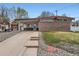 Inviting mid-century home featuring a covered carport and a unique brick facade and well-kept lawn at 5294 S Prescott St, Littleton, CO 80120