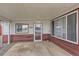 Covered porch featuring a storm door entry and large windows allowing ample natural light at 5294 S Prescott St, Littleton, CO 80120