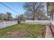 Wide front yard surrounded by a white picket fence on a sunny day at 5294 S Prescott St, Littleton, CO 80120