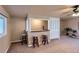Inviting living room with bar seating, plush carpeting, and a ceiling fan for added comfort at 5294 S Prescott St, Littleton, CO 80120