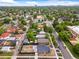 Community aerial showcasing a home with solar panels surrounded by lush greenery and city views at 3458 N Clayton St, Denver, CO 80205