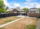 Spacious backyard featuring a pergola, landscaping, and black fencing at 3458 N Clayton St, Denver, CO 80205