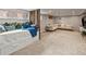 Spacious basement with a bed, a large sectional couch and neutral carpet providing a versatile living space at 3458 N Clayton St, Denver, CO 80205