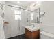 Modern bathroom featuring a glass-enclosed shower, stylish vanity, and sleek fixtures and black honeycomb tile floor at 3458 N Clayton St, Denver, CO 80205