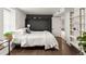 Stylish bedroom featuring a Murphy bed, sleek dark walls, and modern shelving accents at 3458 N Clayton St, Denver, CO 80205