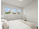 Bright bedroom with natural light flooding in through the multiple windows, complemented by fresh, white walls at 3458 N Clayton St, Denver, CO 80205