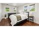 Bright bedroom featuring hardwood floors, a neutral color scheme, and plenty of natural light through the windows at 3458 N Clayton St, Denver, CO 80205
