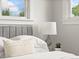 Inviting bedroom with a plush headboard, soft bedding, and windows for natural light and fresh air at 3458 N Clayton St, Denver, CO 80205