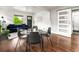 Dining area with a glass table, modern chairs, and hardwood floors adjacent to living room at 3458 N Clayton St, Denver, CO 80205