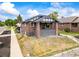 Charming brick bungalow with a covered front porch and a well-maintained front yard at 3458 N Clayton St, Denver, CO 80205