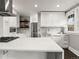 Open kitchen boasts a spacious island, stainless appliances, and ample natural light from the adjacent windows at 3458 N Clayton St, Denver, CO 80205