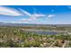 Stunning aerial view of a neighborhood near a lake surrounded by green trees and blue sky with clouds at 4434 Grove St, Denver, CO 80211