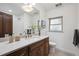 Bathroom vanity with marble countertop, wood cabinets, and modern fixtures at 4434 Grove St, Denver, CO 80211