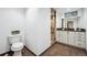Bathroom featuring a toilet, vanity with drawers, and a glass-door shower at 4434 Grove St, Denver, CO 80211