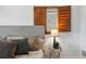 Bedroom featuring decorative window shutter, hardwood floors, and neutral tones at 4434 Grove St, Denver, CO 80211
