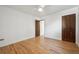 Bedroom featuring hardwood floors, a ceiling fan, and a wooden door at 4434 Grove St, Denver, CO 80211