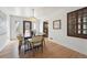 Bright dining area with a modern chandelier, a wooden table, and hardwood floors at 4434 Grove St, Denver, CO 80211