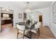 Elegant dining room with a modern light fixture, hardwood floors, and an open view to the kitchen at 4434 Grove St, Denver, CO 80211