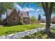 Beautiful brick house with a manicured lawn and mature trees, offering great curb appeal at 4434 Grove St, Denver, CO 80211