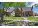 Charming brick home featuring a well-maintained lawn and a turret on a sunny day at 4434 Grove St, Denver, CO 80211