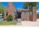 Charming brick home features a quaint covered entry and well-maintained front yard landscaping at 4434 Grove St, Denver, CO 80211
