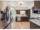 Bright kitchen featuring stainless steel appliances, wood cabinets, and sun-lit breakfast nook at 4434 Grove St, Denver, CO 80211