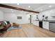 Open living space with recessed lighting, wood floors, and an adjacent sink and countertop at 4434 Grove St, Denver, CO 80211