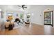 Bright living room featuring stylish decor, large windows, a fireplace and hardwood floors at 4434 Grove St, Denver, CO 80211