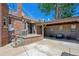 The brick home's outdoor space features a covered patio area with seating and string lights at 4434 Grove St, Denver, CO 80211