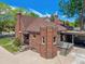 Brick home showcases well-maintained landscaping and hardscaping, exterior chimney and roof at 4434 Grove St, Denver, CO 80211