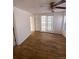 Bedroom with hardwood floors, built-in shelves, and sliding door to patio at 926 Perry St, Denver, CO 80204