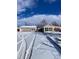 Two-car garage and cozy house exterior in winter setting at 926 Perry St, Denver, CO 80204