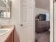 Clean bathroom with vanity and access to bedroom at 516 Tanager St, Brighton, CO 80601