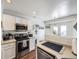 Well-equipped kitchen includes stainless steel range and microwave at 516 Tanager St, Brighton, CO 80601